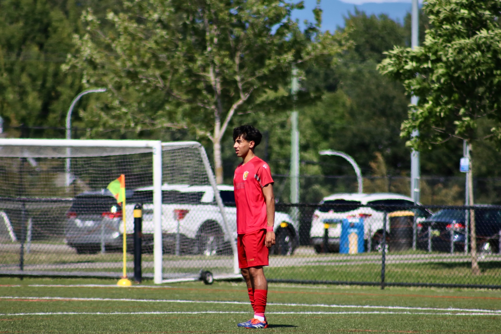 Coach Afshin Shahbazi on the field in red kit